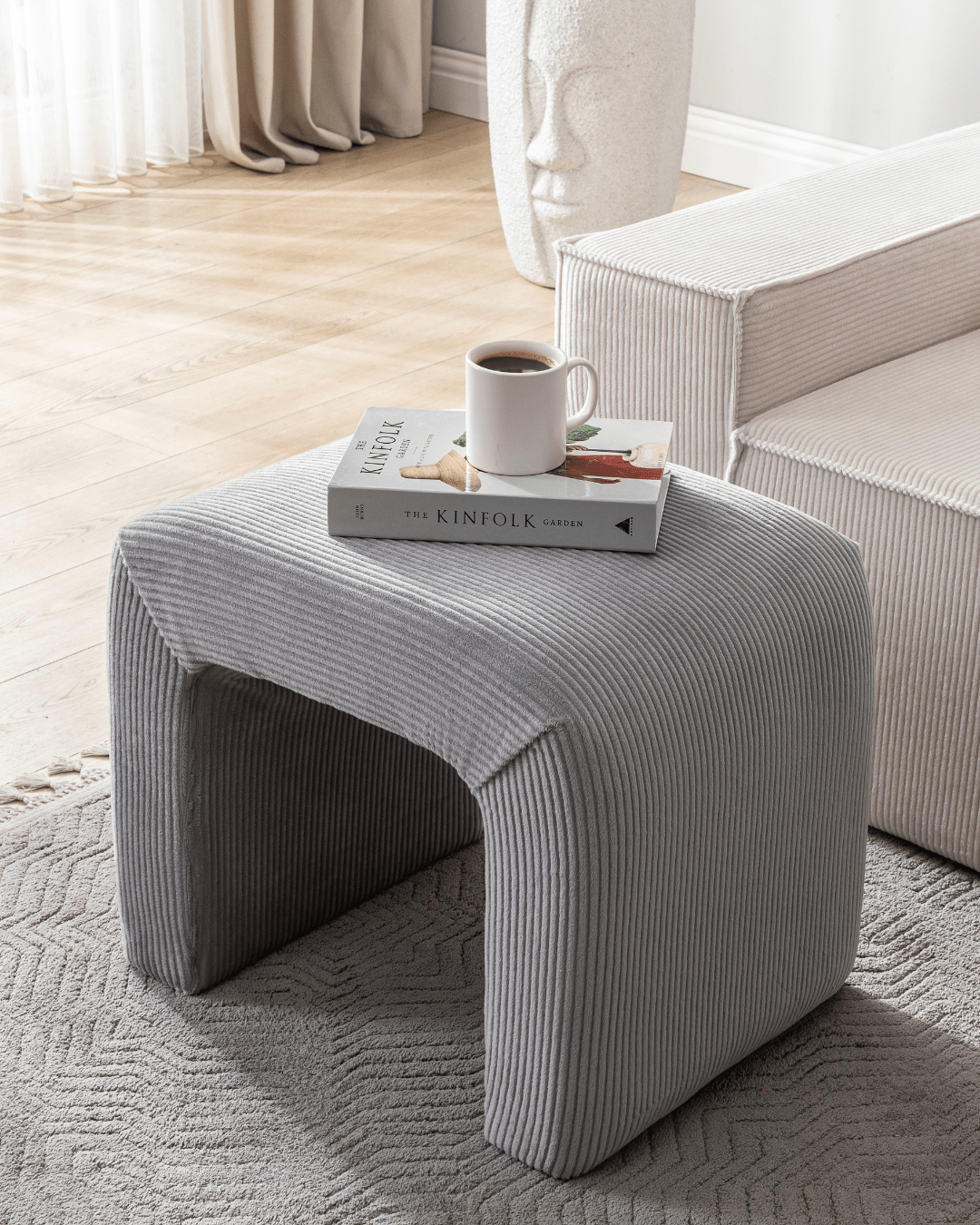 A corduroy-crafted Confex Ottoman Mesa that blends smooth texture and sculptural charm in modern decor.