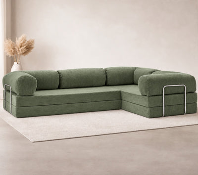 Confex Corner Green Sofa displayed in a minimalist living room with olive green corduroy upholstery, rounded armrests, plush cushions, neutral walls and a soft beige rug.