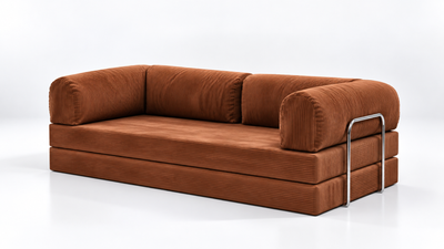 Three quarter view of the Confex corduroy couch in an earthy orange shade, highlighting its ribbed upholstery, relaxed seating proportions and rounded arms against a minimal studio backdrop.
