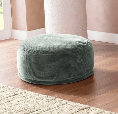 Sofio Round Ottoman Pouf in soft green corduroy adds cozy texture and balance to modern home interiors.